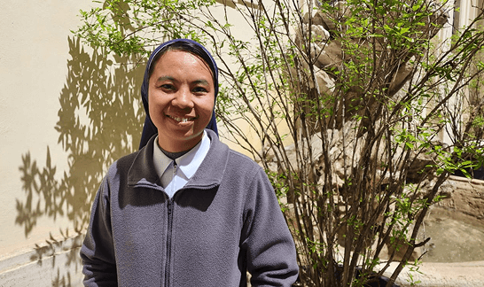 sister_genevie Sister Genevieve smiling next to plants