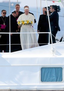 Pope Francis tosses a wreath of flowers into the Mediterranean Sea off the Italian island of Lampedusa in this July 8, 2013, file photo. The pope threw a wreath to honor the memory of immigrants who have died trying to cross from Africa to reach a new life in Europe. Pope Francis, formerly Argentine Cardinal Jorge Mario Bergoglio, died April 21, 2025, at age 88. (CNS photo/pool) (July 7, 2014)