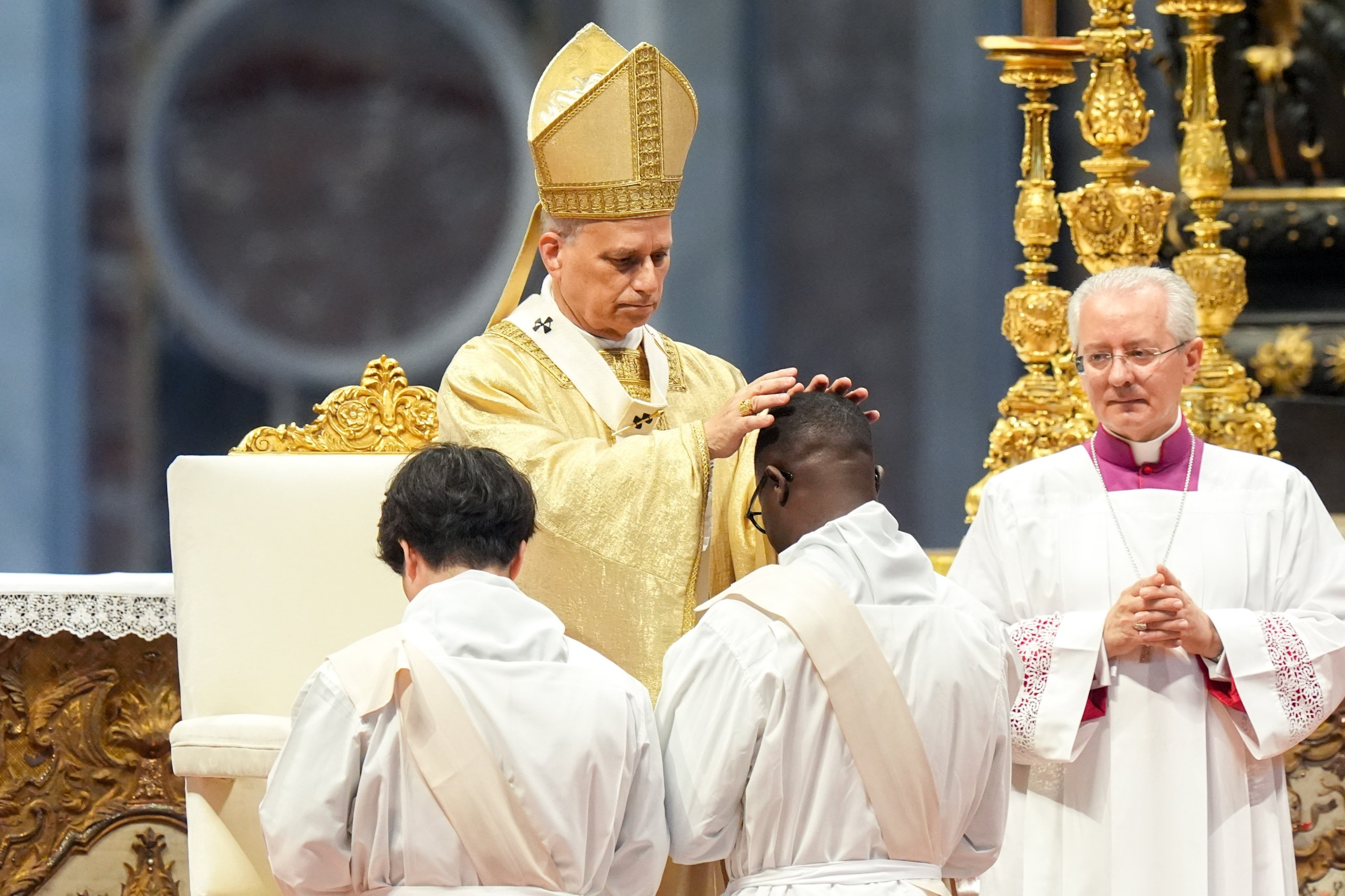Pope Leo XIV lays hands on an ordinand during Mass on the feast of the Sacred Heart of Jesus in St. Peter’s Basilica at the Vatican June 27, 2025. The pope ordained 32 men from five continents. (CNS photo/Lola Gomez)